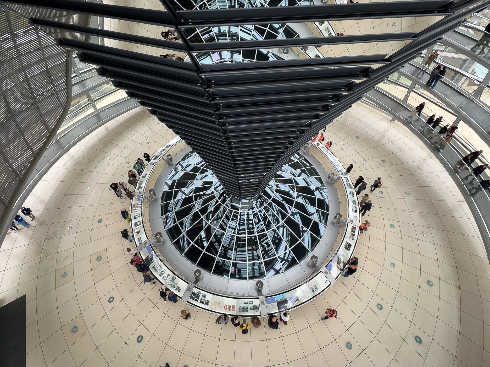 a large glass dome with people standing around