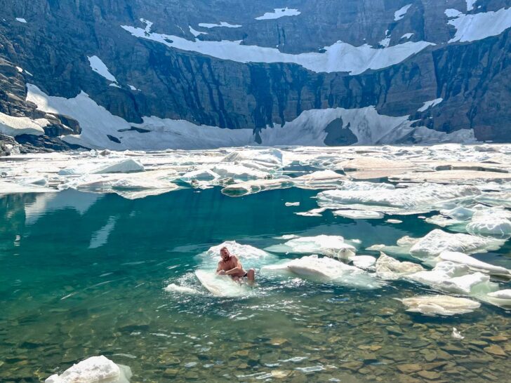 Man swimming in Iceberg Lake Glacier National Park