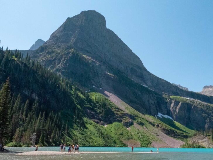 People swimming in Grinnell Lake in Glacier National Park