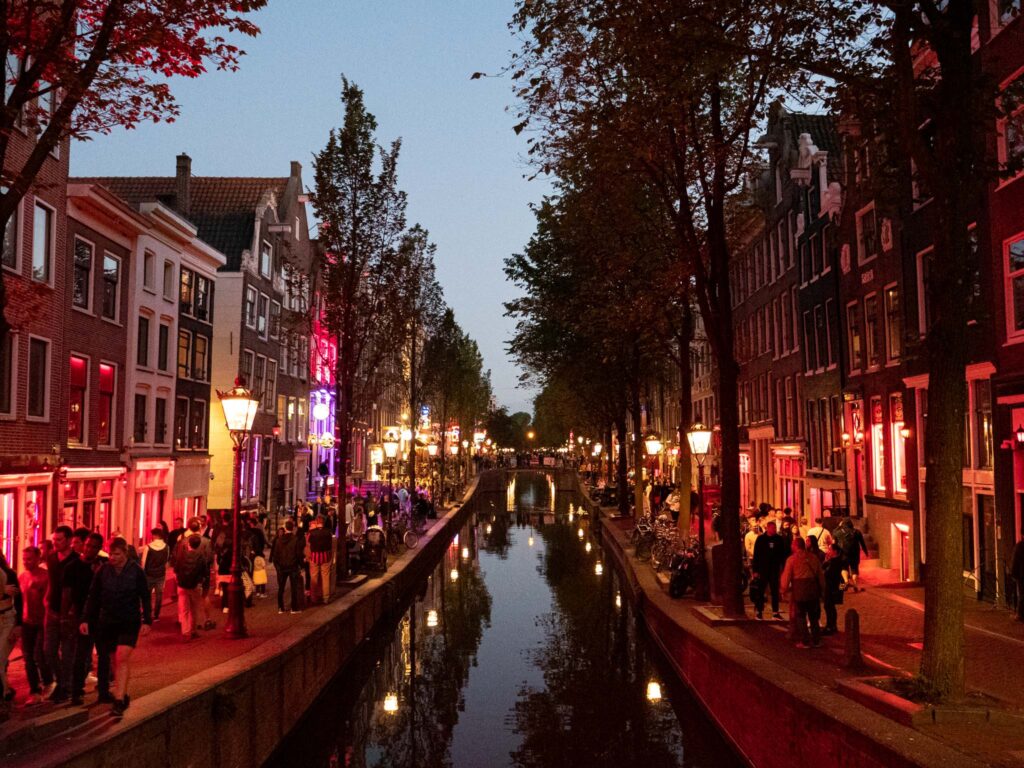 a canal with people and buildings in the background