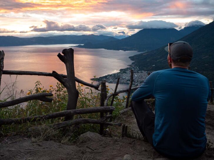 Man sitting down watching Lake Atitlan sunrise from Indian Nose Rostro Maya