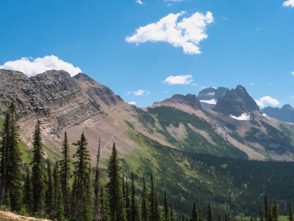 a mountain range with trees and mountains in the background