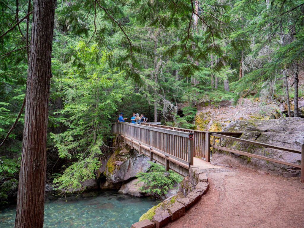 a group of people on a bridge over a river