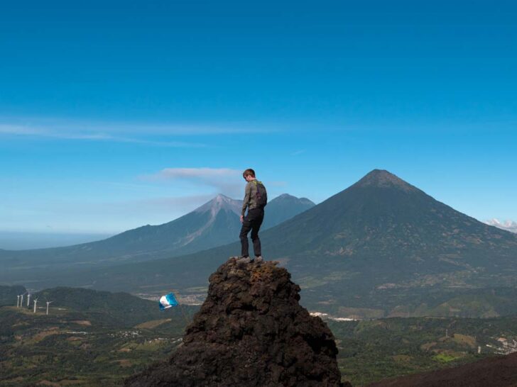 Man standing on rock formation at Pacaya Volcano in Guatemala