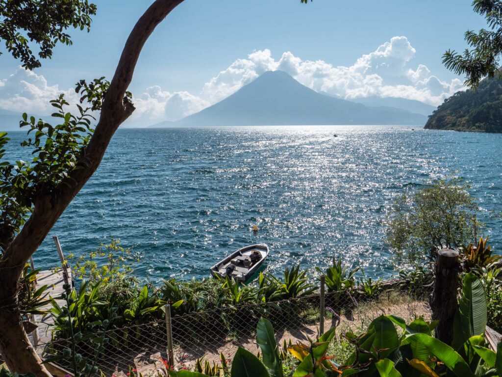 a boat on the water with Lake Atitlán in the background