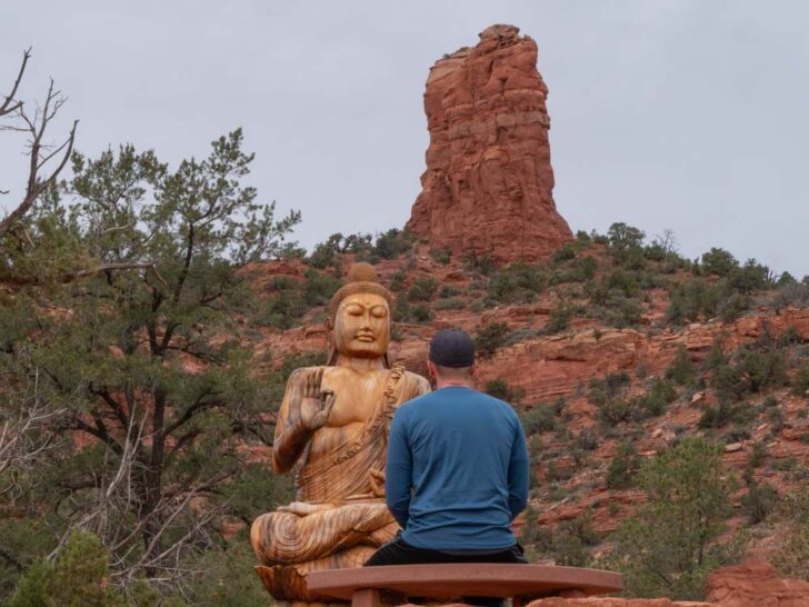 Man meditating at Buddha Statue at Amitabha Stupa and Peace Park Sedona Arizona
