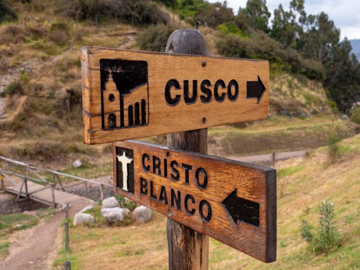 Wooden entrance sign near the ruins of Sacsayhuaman Cusco Peru