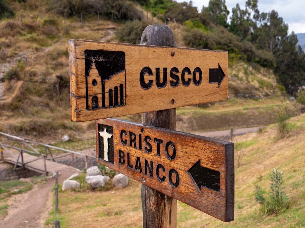 a wooden sign post with a couple of arrows