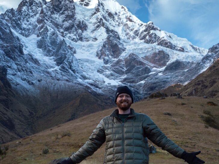 Man posing in front of large mountain near Salkantay Pass Peru