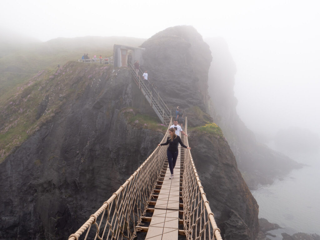 Visitors crossing the rope bridge to Carrick a Rede