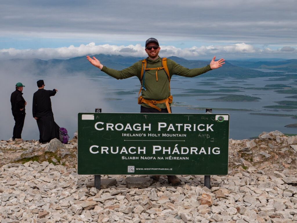 a man standing in front of a sign