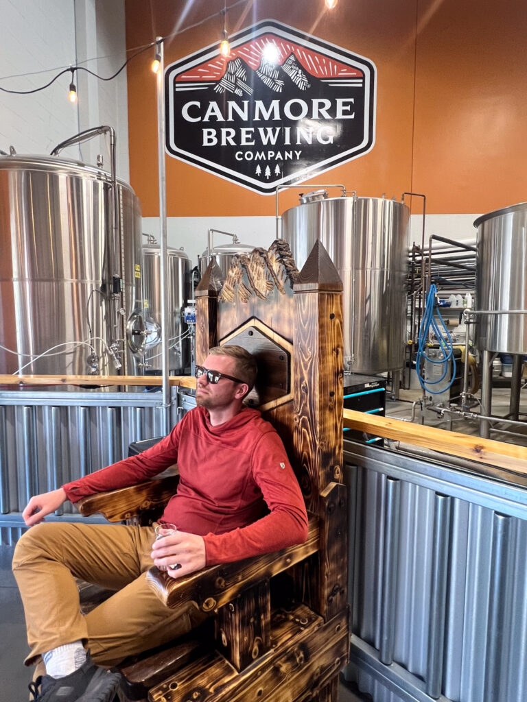 Man posing for photo at Canmore Brewing, Canada