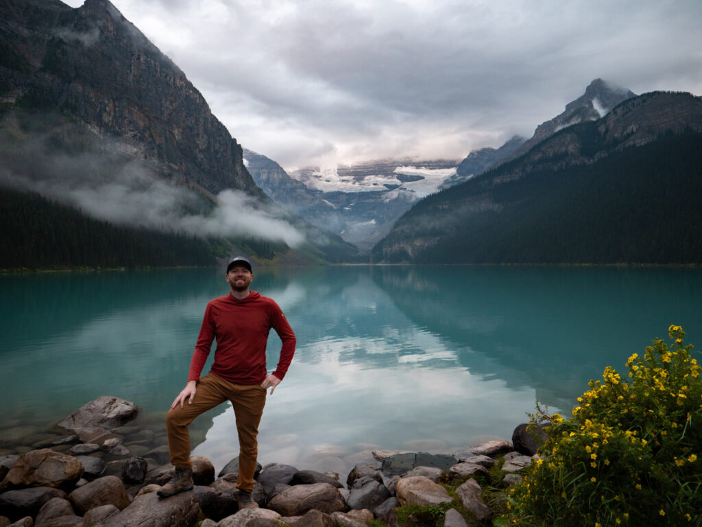 Man taking photo in front of Lake Louise, Banff National Park