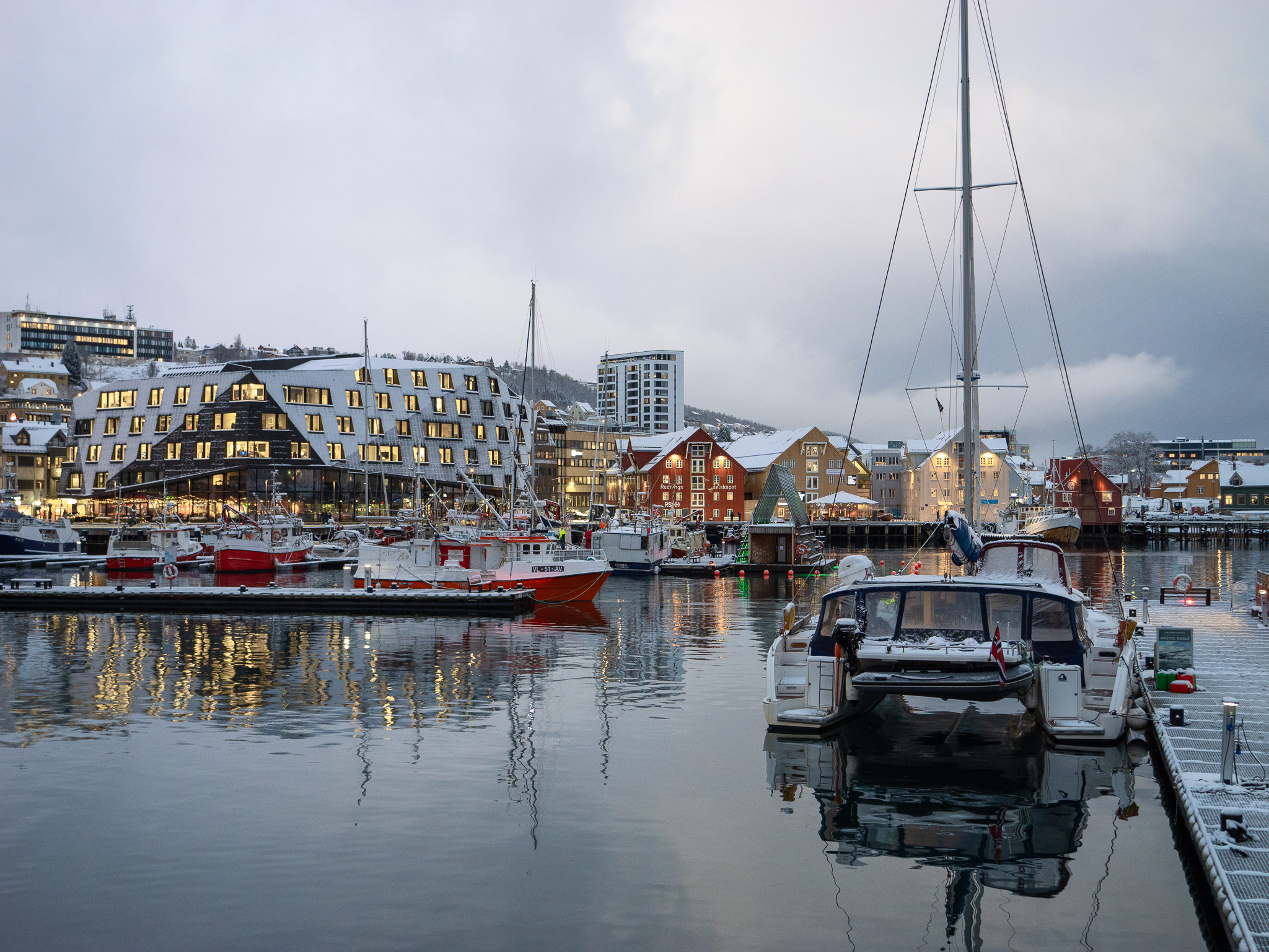 boats on the water with buildings in the background