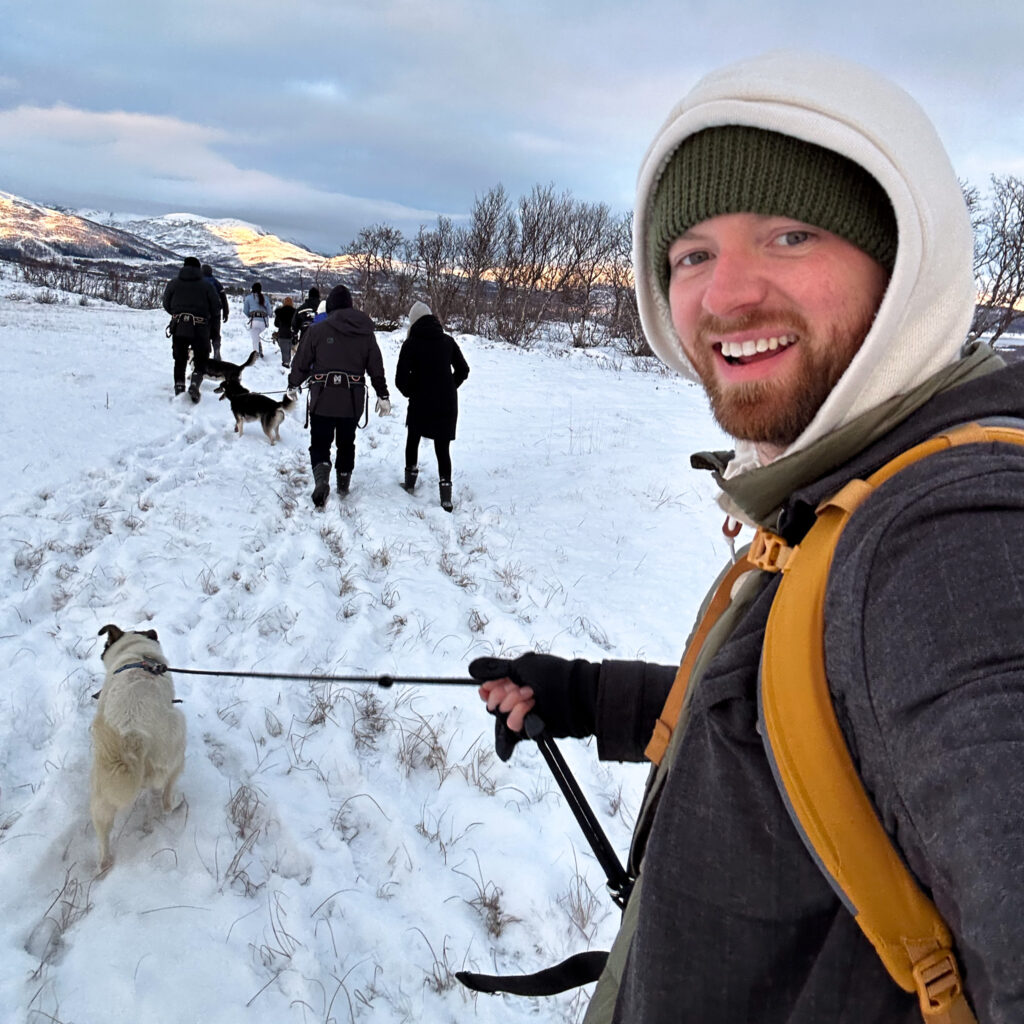 Man enjoying husky hike in Tromso Norway