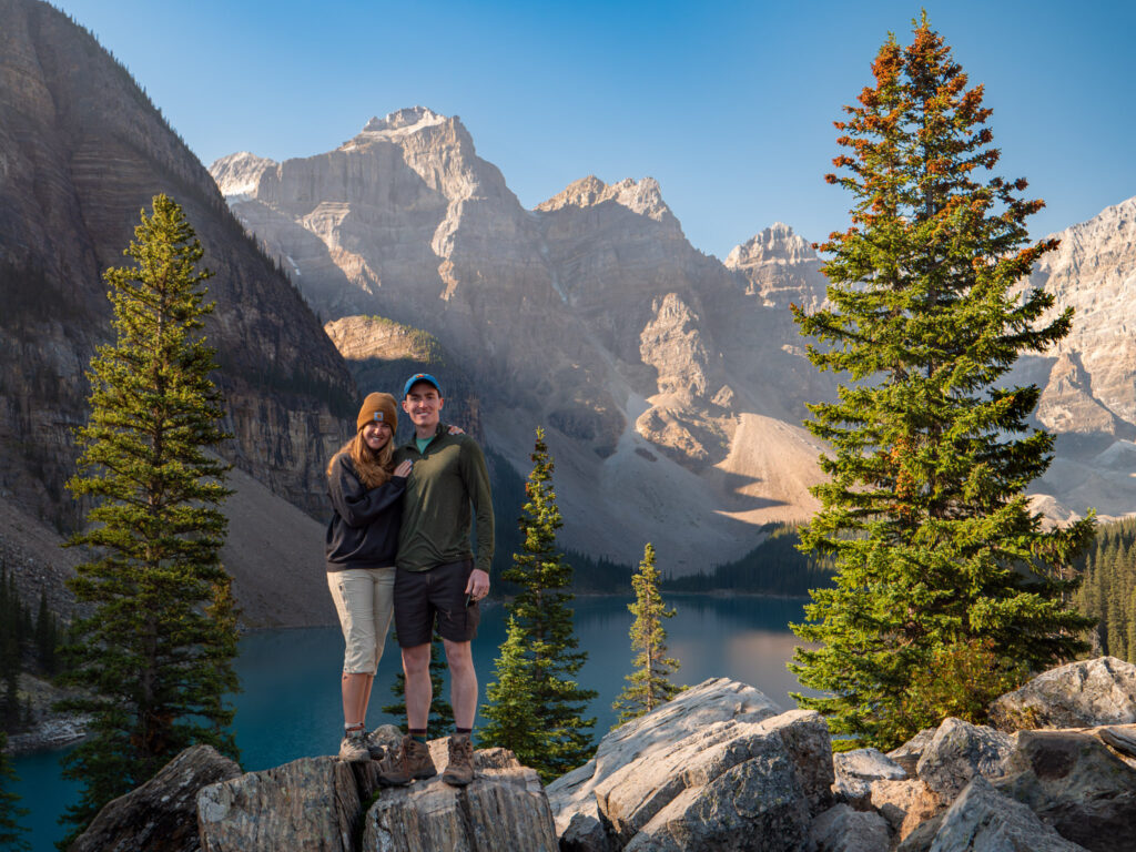 couple posing at the Moraine Lake Rock Pile in Banff National Park