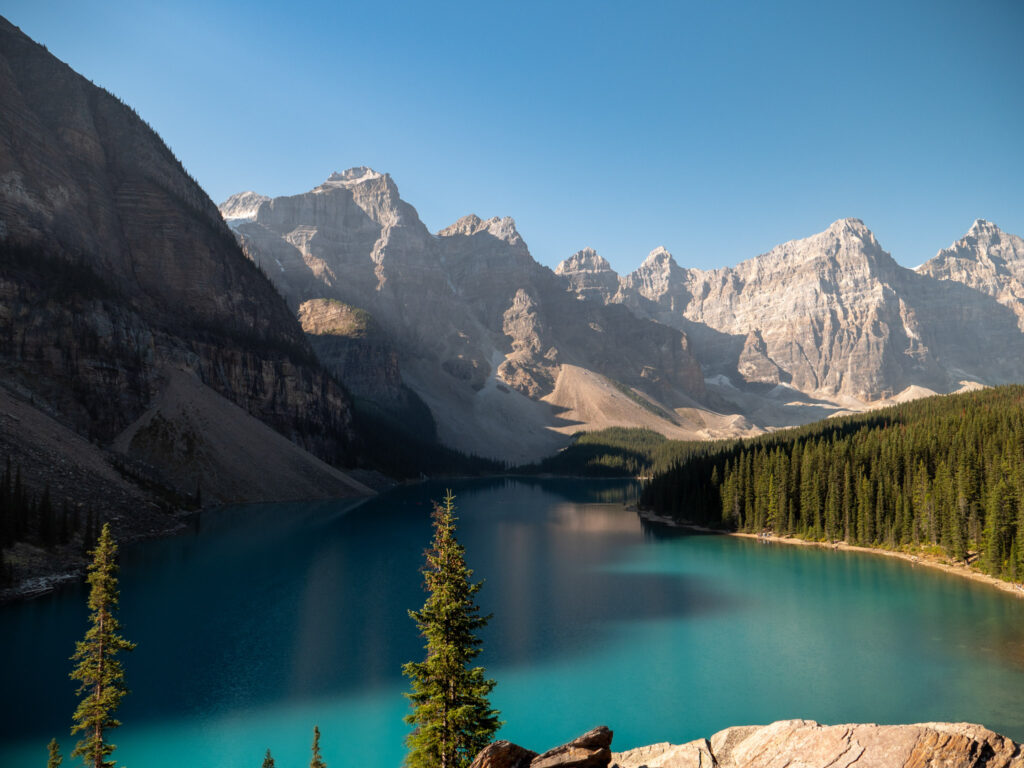 Turquoise waters of Moraine Lake during sunrise in Alberta Canada