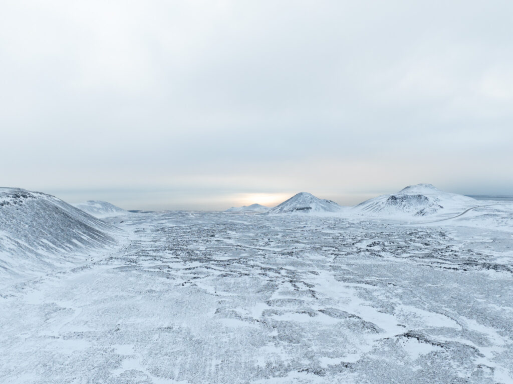 Snowy Icelandic terrain with cloudy skies near Grindavik