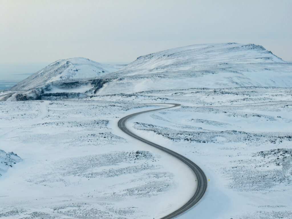 Windy road cutting through the Icelandic countryside during winter