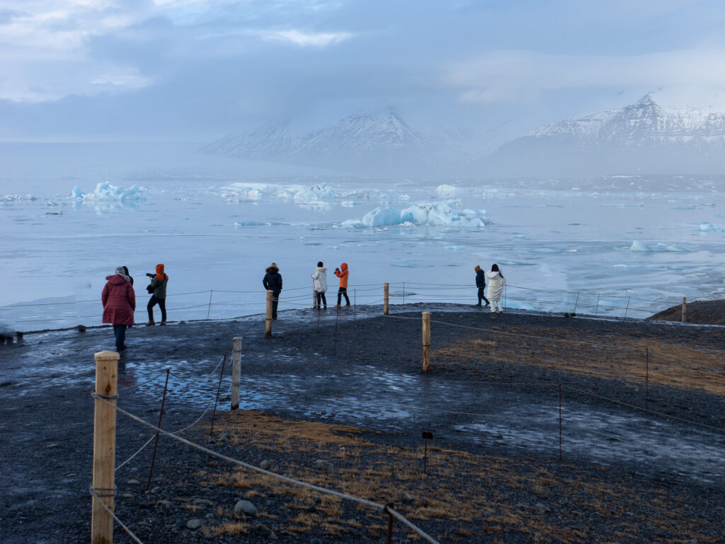 Visitors looking out over Jokulsarlon Glacier Lagoon