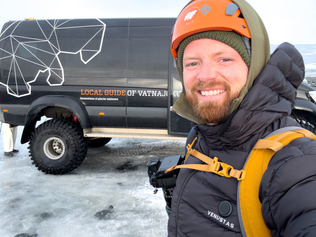 Man standing in front of black super jeep in Iceland