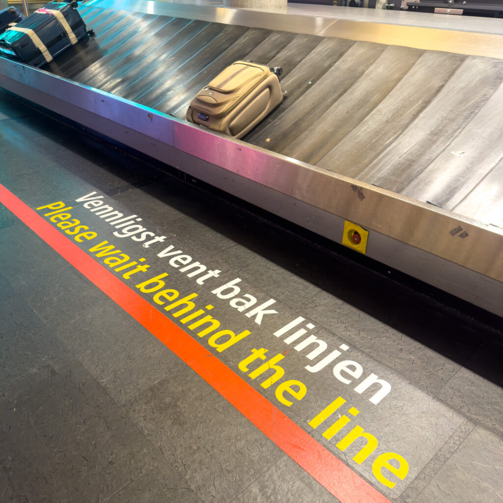 Signage on the ground in a Norwegian Airport