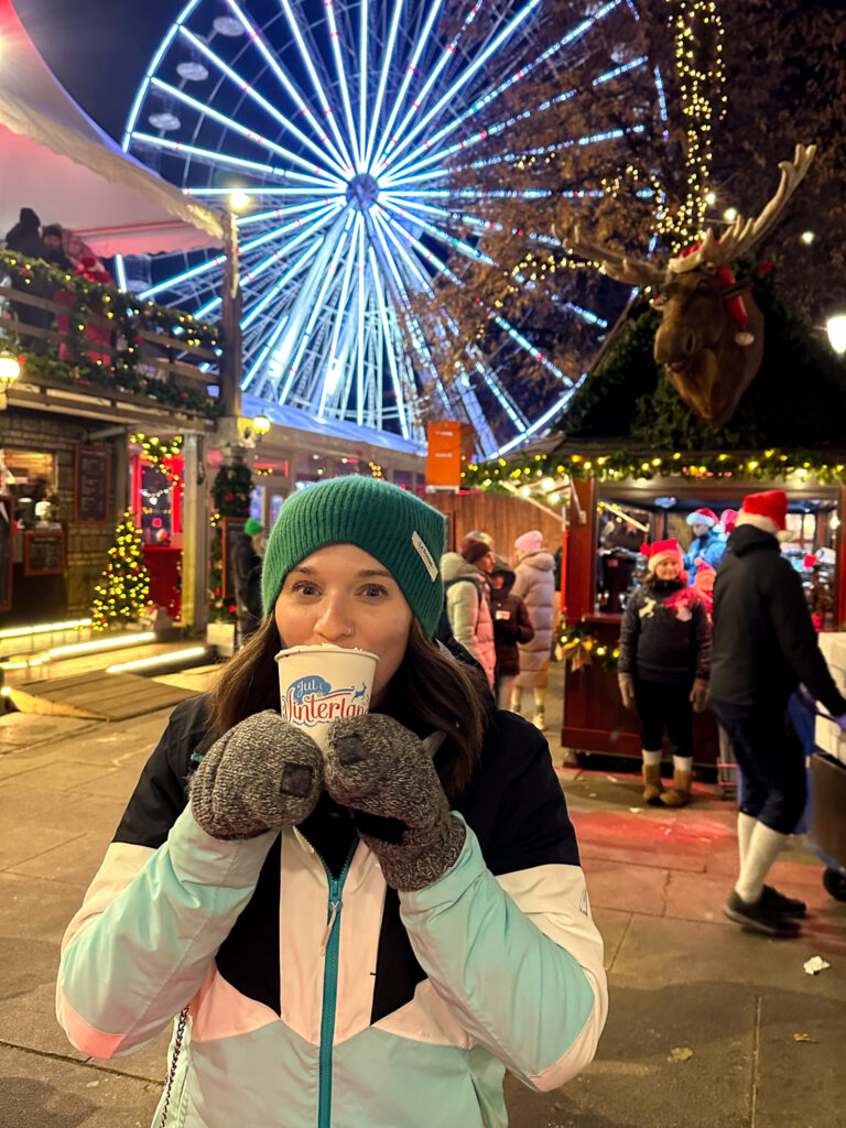 Woman sipping hot chocolate at the Oslo Christmas Market