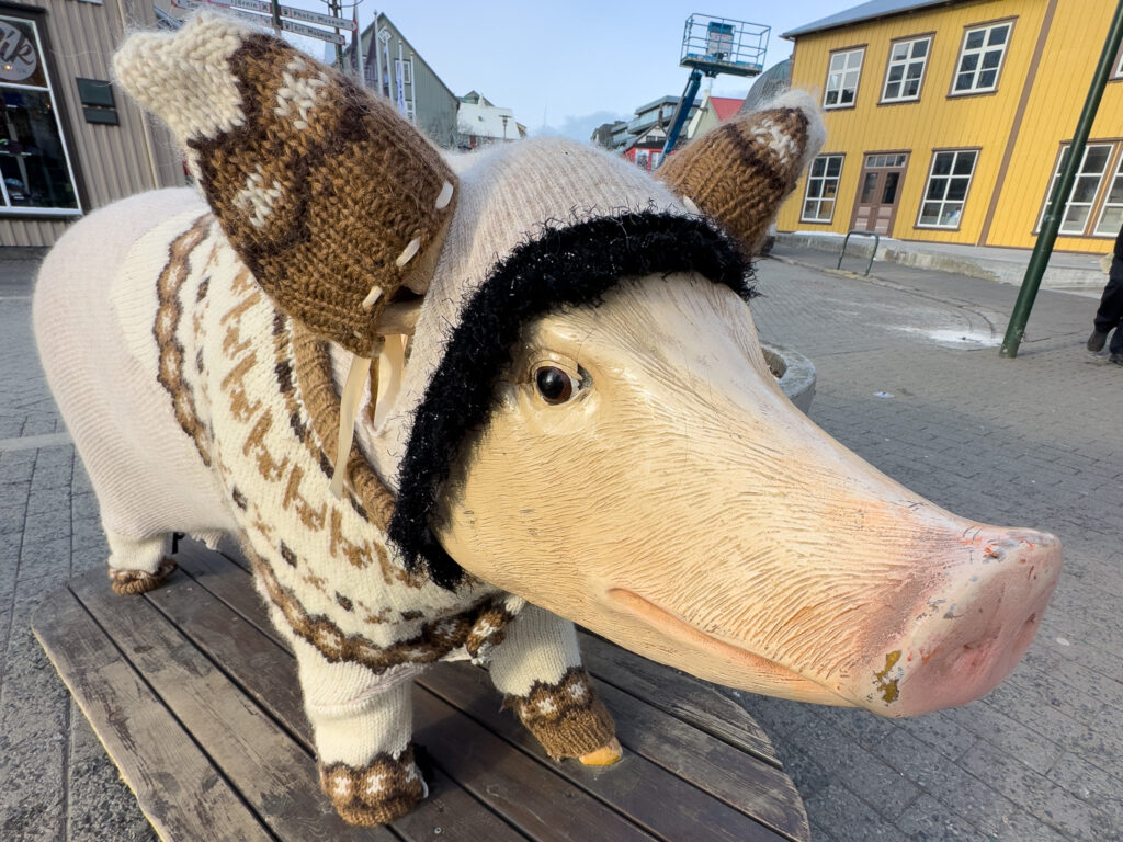 Statue of a pig wearing a sweater