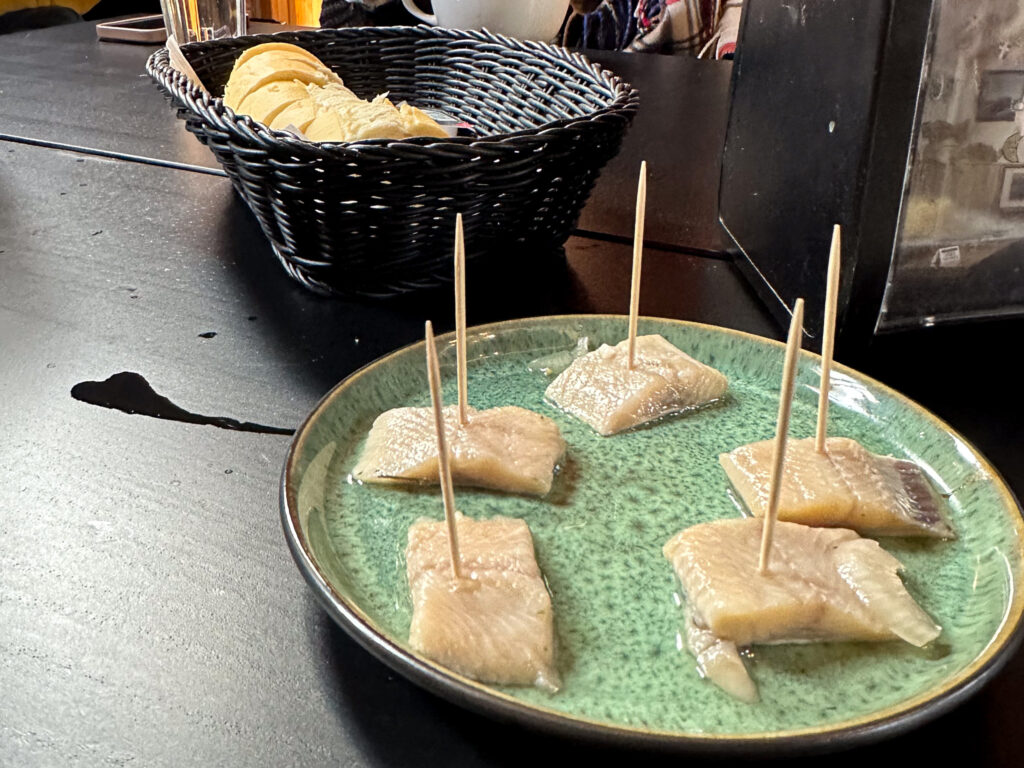 Pickled herring appetizers on toothpicks