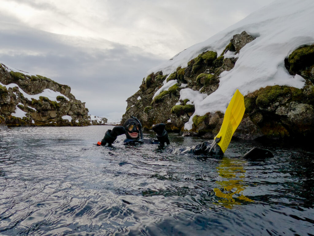 Dive instructor teaching students safety precautions in Iceland