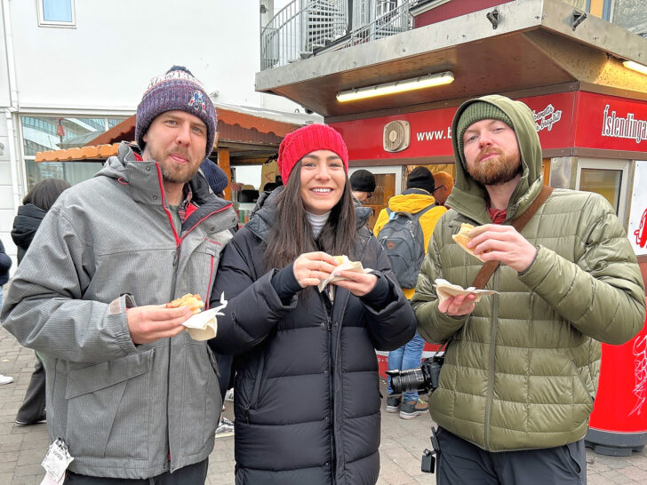 Group of people eating hot dogs in Reykjavik
