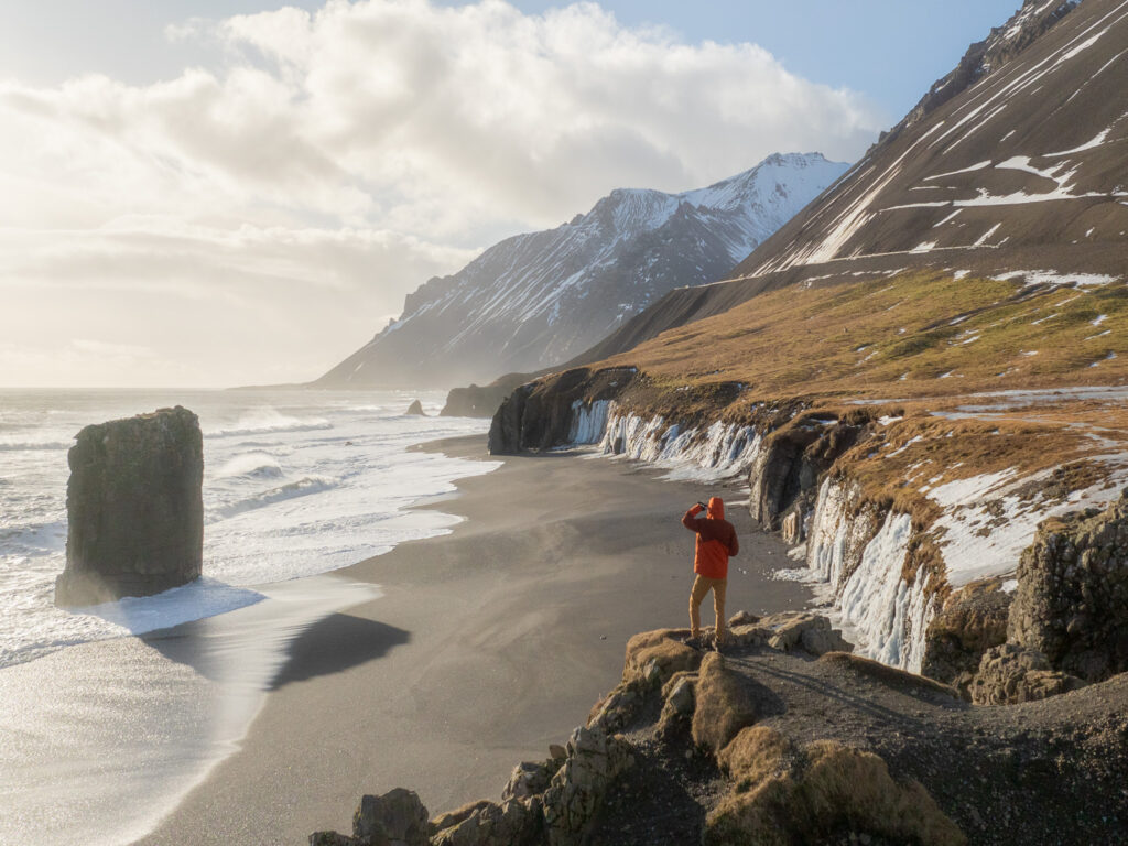 a person standing on a rocky beach