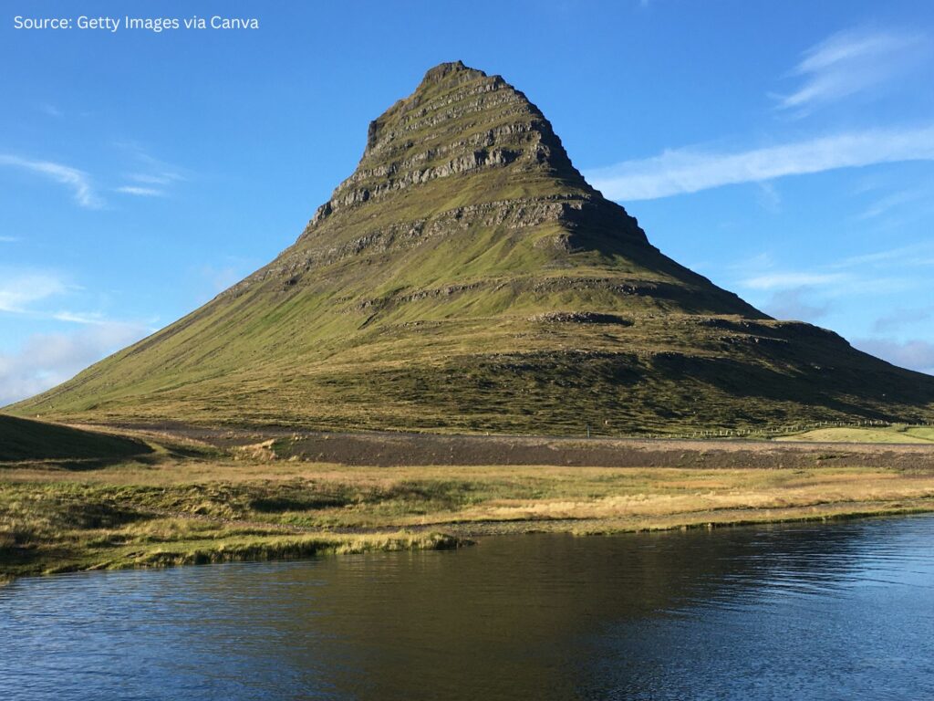 a mountain with a body of water