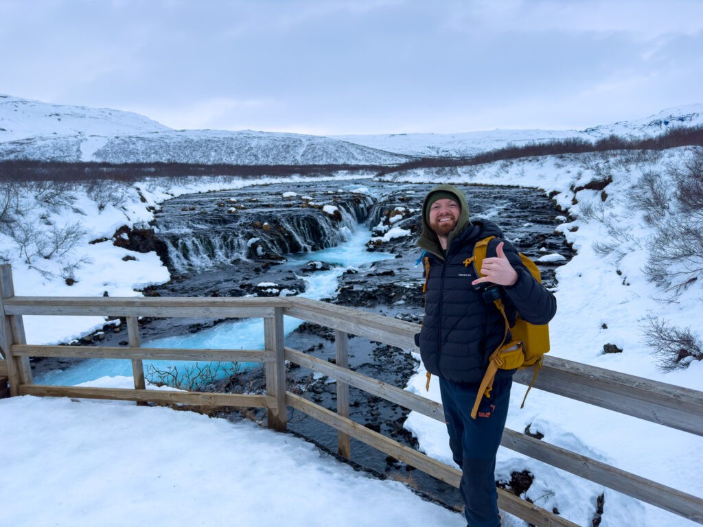 man standing near a waterfall