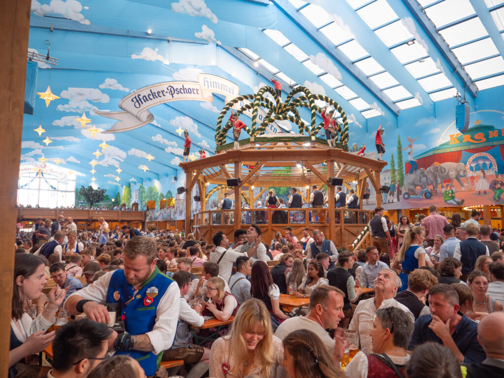 a large group of people sitting at tables in a tent