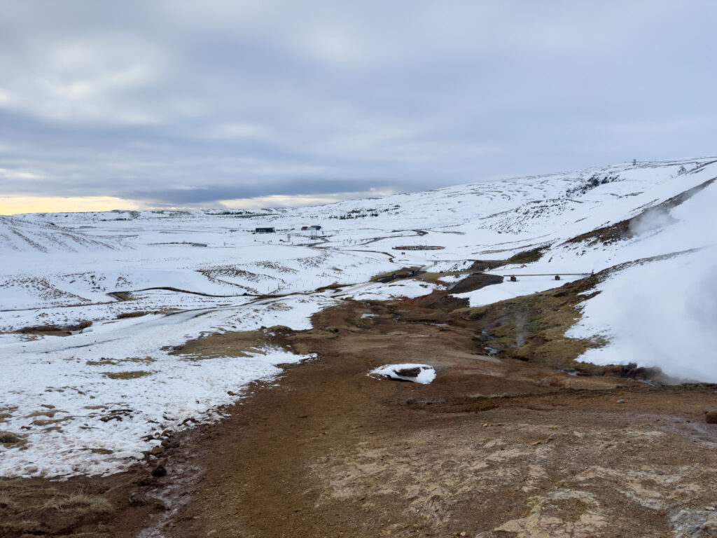 a snowy landscape with a dirt road