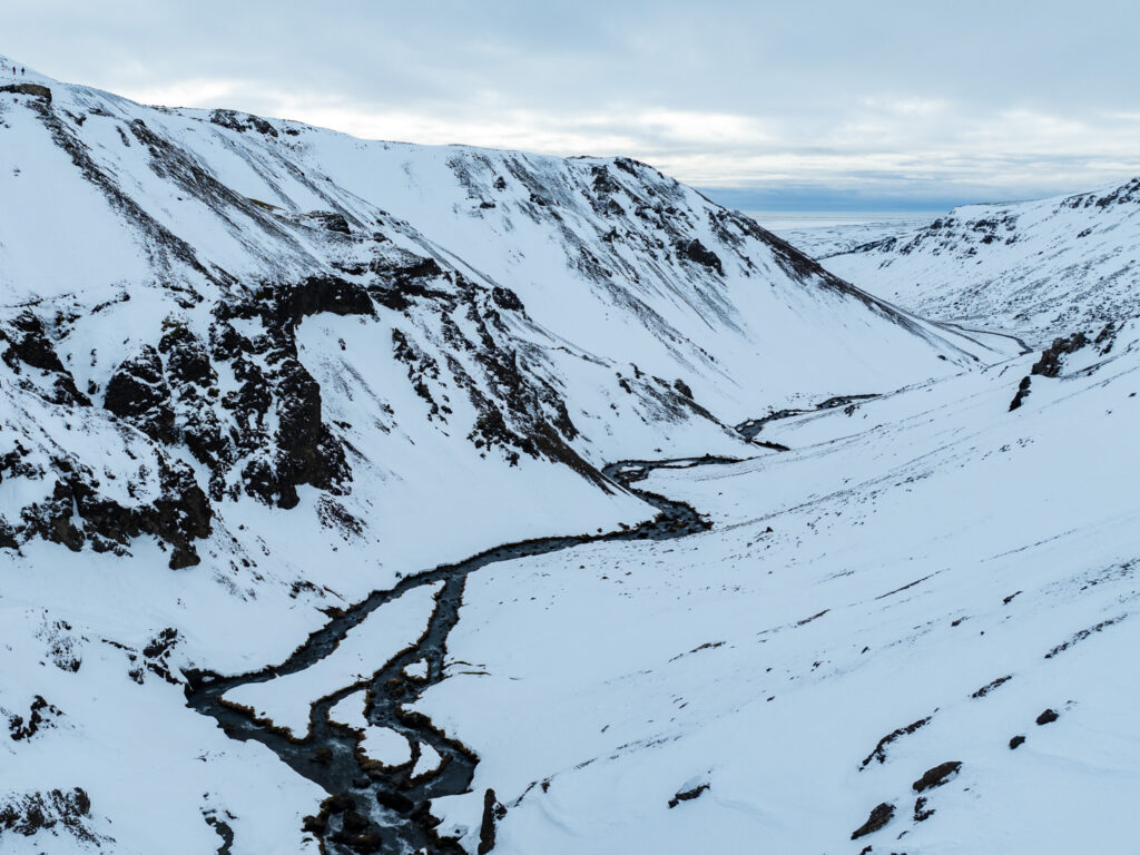 a river running through a snowy valley